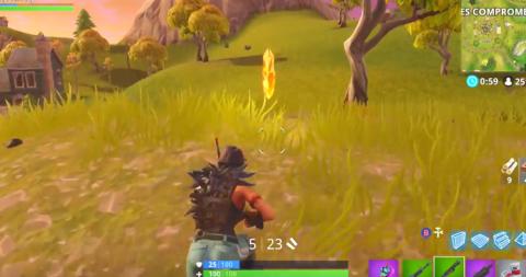 Search between a scarecrow, pink racing car and a big screen in Fortnite Battle Royale