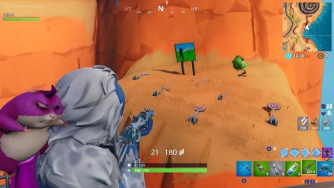Get a score of 5 in the shooting gallery east of Ostentatious Oasis in Fortnite
